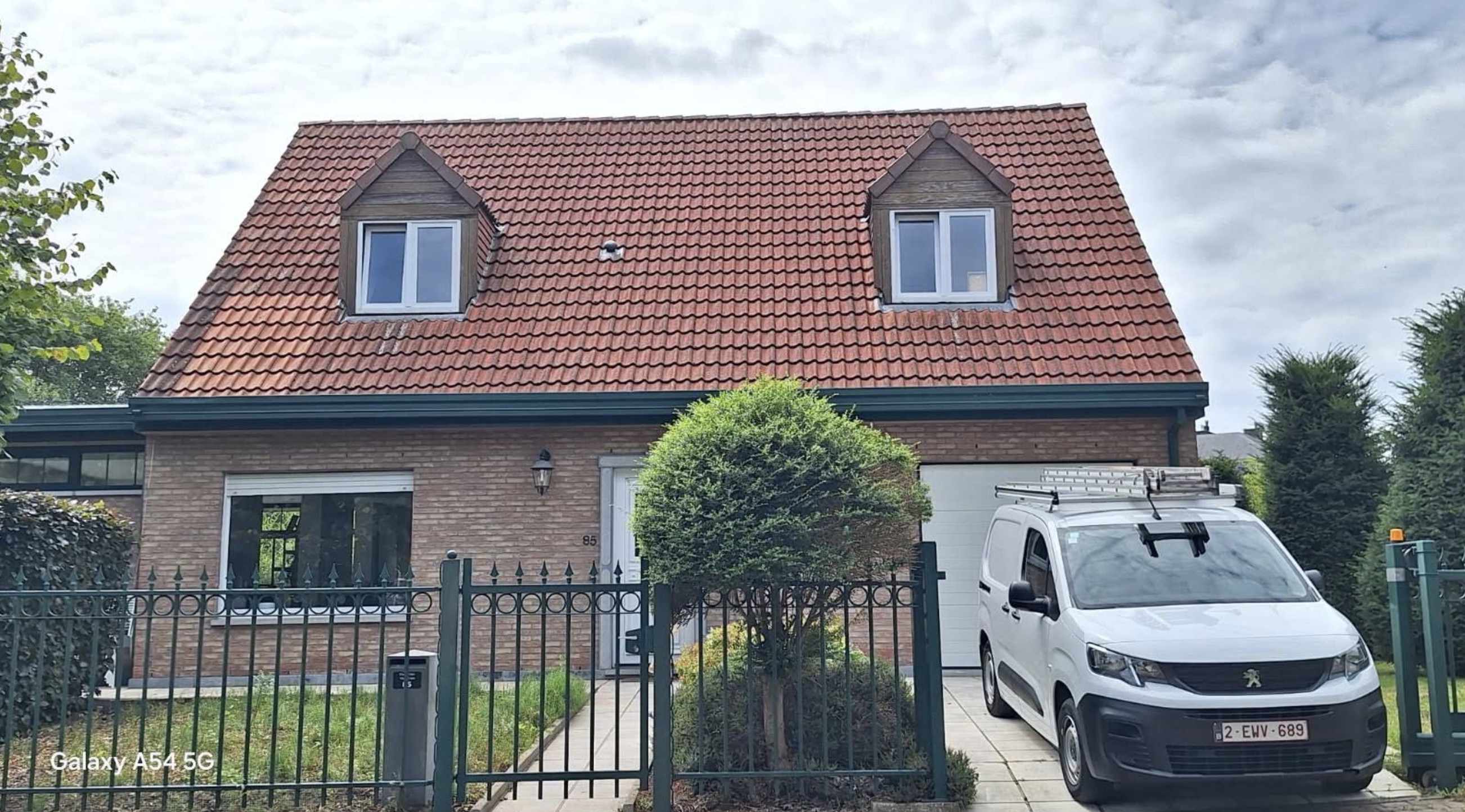 Maison en brique avec toiture en tuiles, vue de face